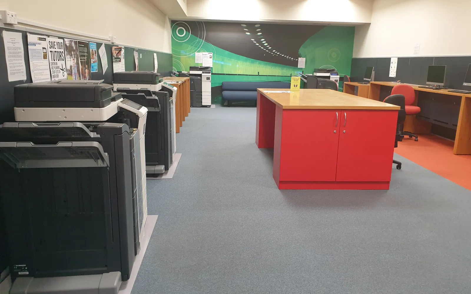 Shared office photocopy room with several multifunction printers